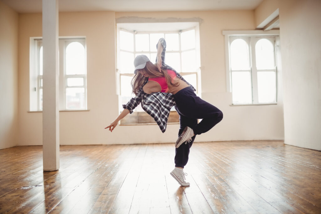 Pretty woman practising hip hop dance in studio